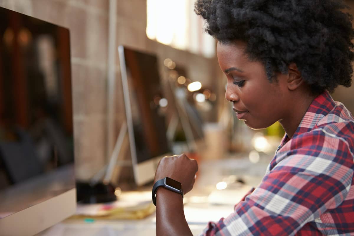 A woman in supply chain using a wearable device by allegiance staffing.