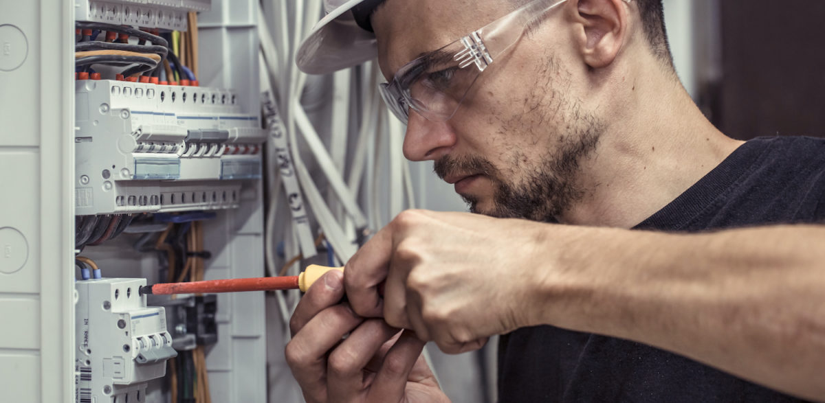 A male electrician working at his jobsite by allegiance staffing.