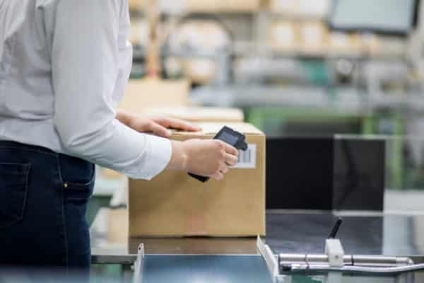 Supply chain professional utilizing rfid tag to register an item.