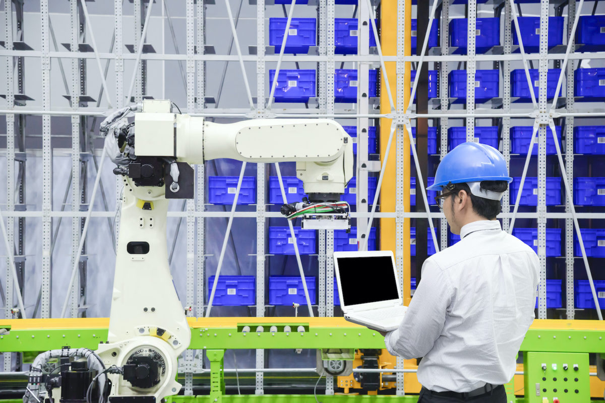 A man working with his supply chain robotics by allegiance staffing.