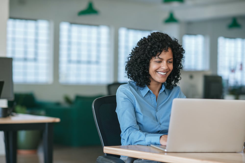 Young woman working in a temp to full time administrative assistant job by allegiance staffing.