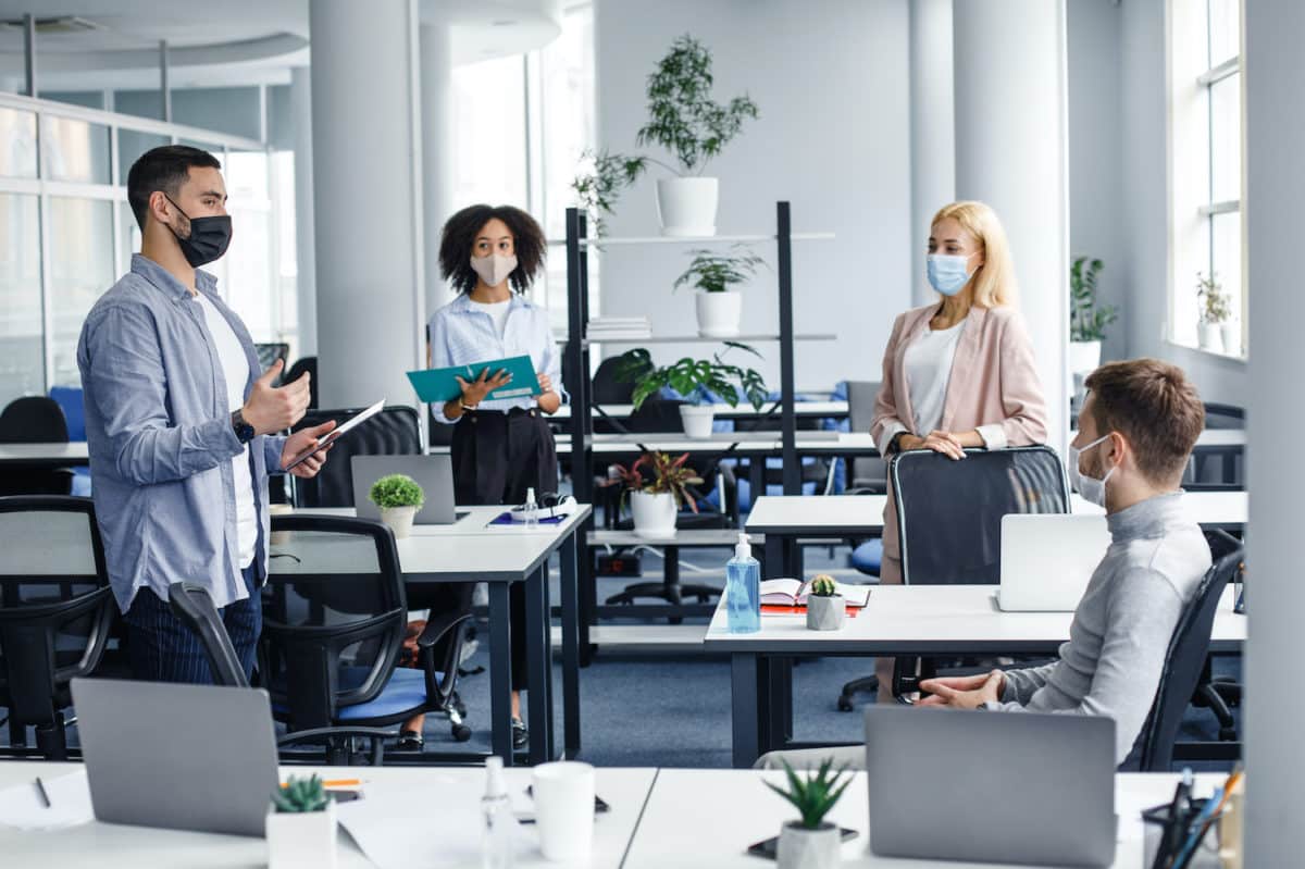 A fully staffed workplace practicing social distancing and wearing masks by allegiance staffing in houston, texas.