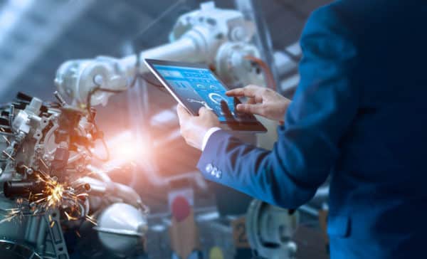 Manufacturing manager using technology to move a robot after hiring for other manufacturing positions