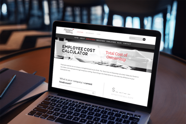 Utilize the Allegiance Staffing Employee Cost Calculator 8 mockup of a macbook placed on a coffee table 2313 el1 1