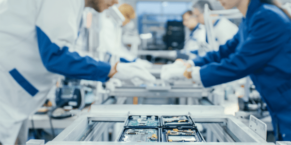 Assembly line factory workers performing duties in a factory