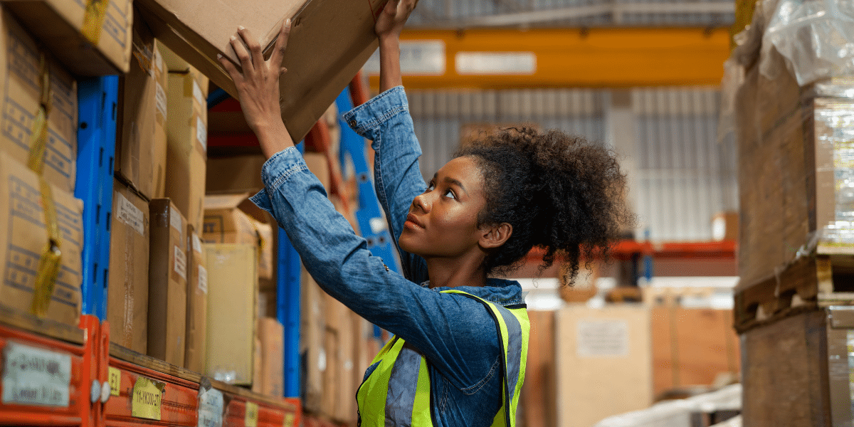 Warehouse employee managing goods after her employer learned how to make the warehouse more efficient