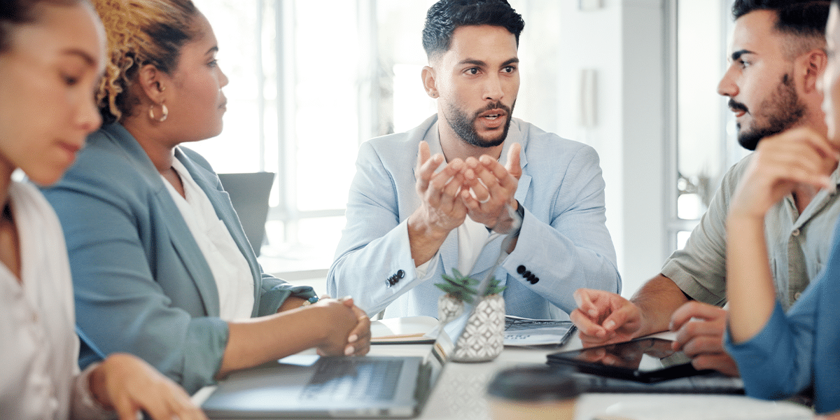 A professional who received an executive management position leading a meeting