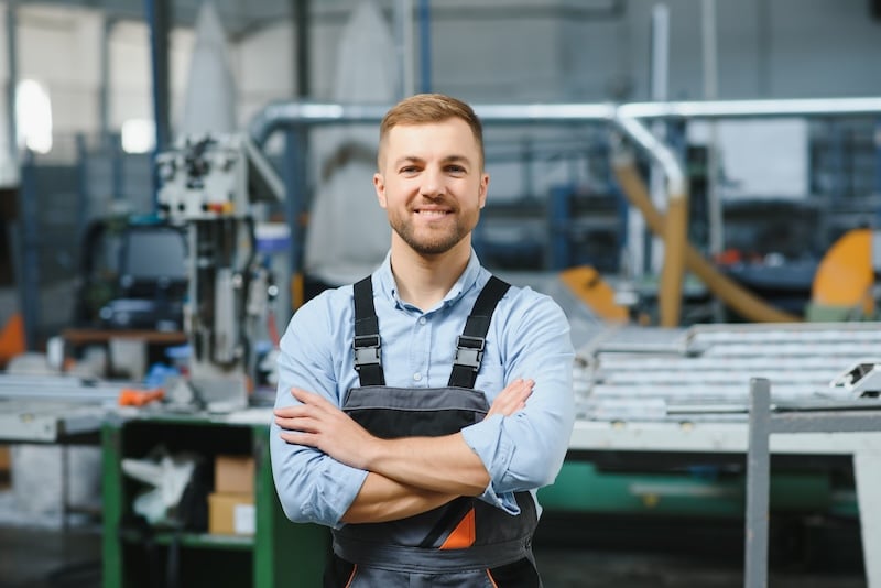 Factory worker enjoying his work after being hired on a temporary basis