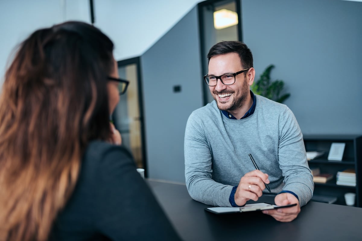 Employer sitting down with an employee to discuss employment opportunities