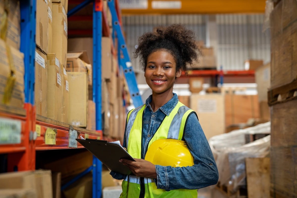 Warehouse worker reviewing safety measures on a clipboard