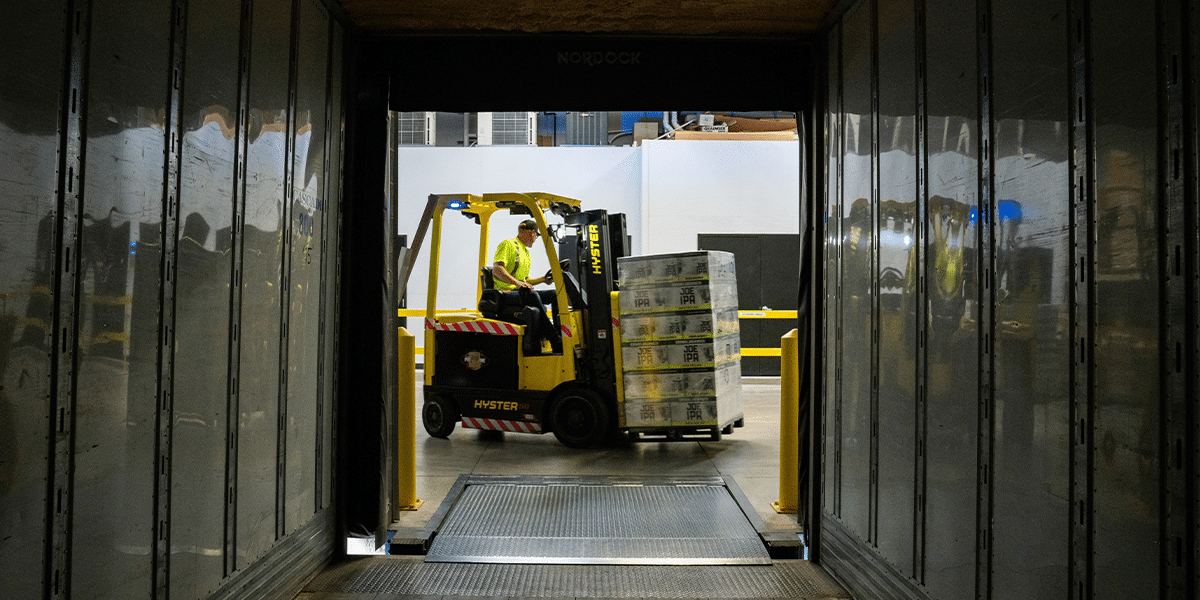 Forklift driver moving boxes to represent forklift driver jobs