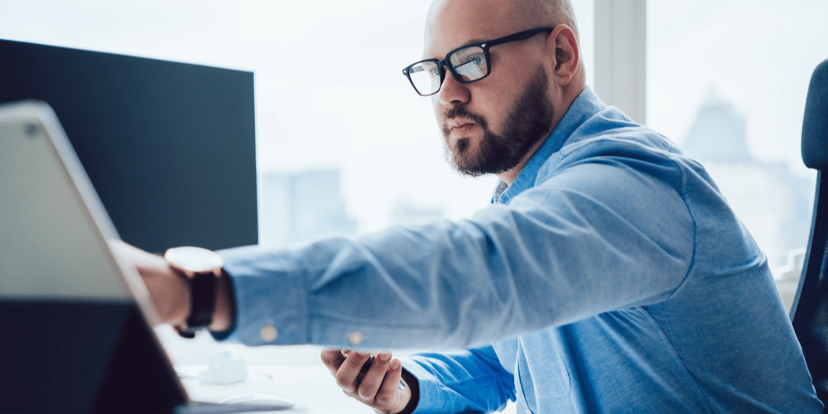 Professional worker performing duties on a computer in an office setting