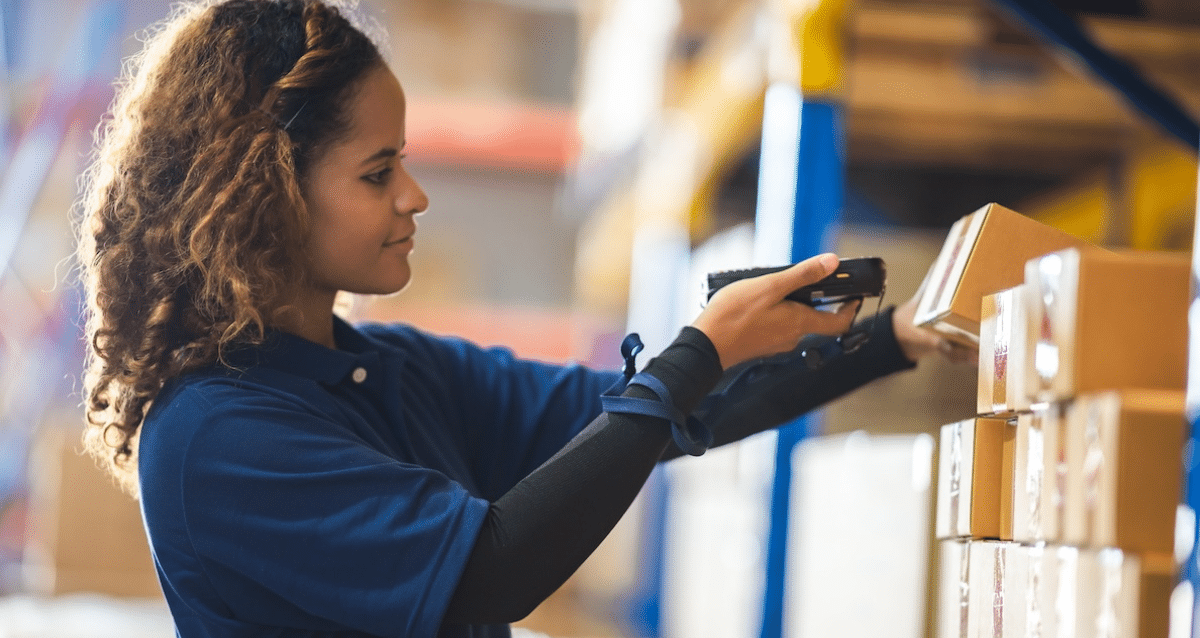 Warehouse worker using software to check inventory levels in the warehouse