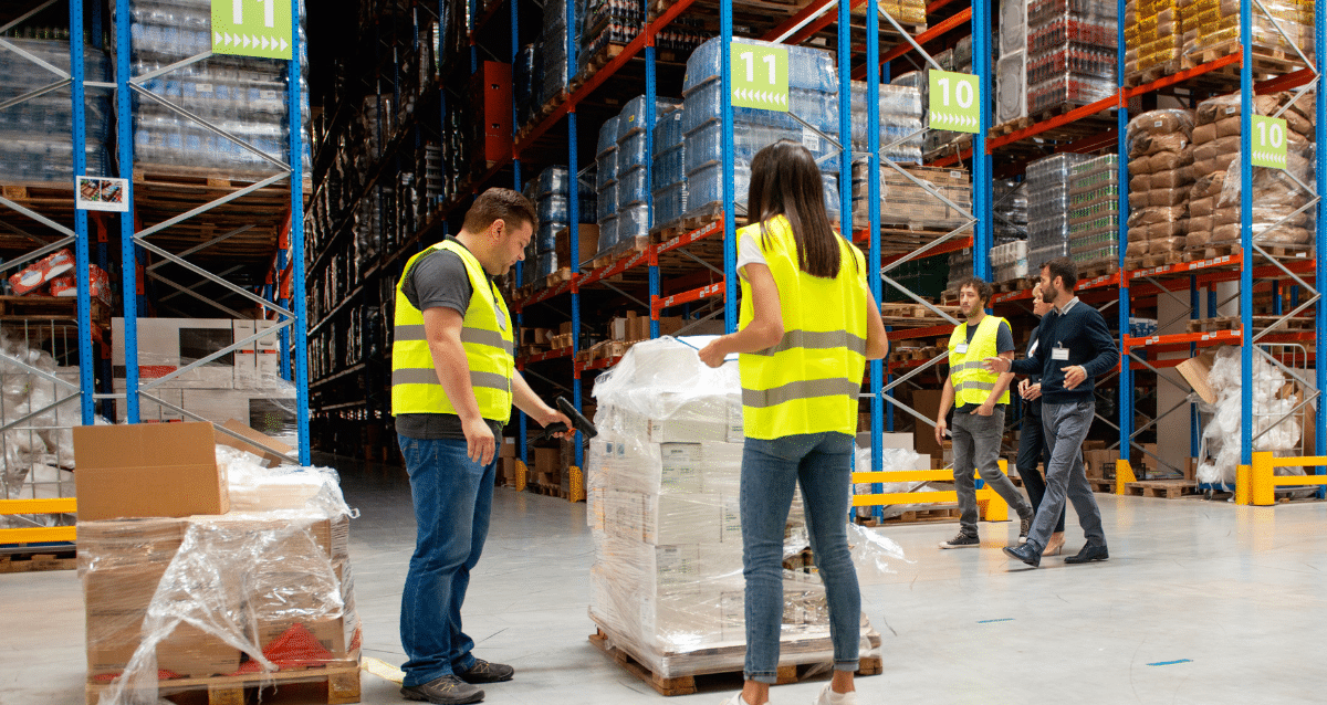 Supply chain workers reviewing materials on a palette